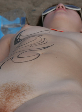 Hairy pussy naturist nude girl has fun on the beach
