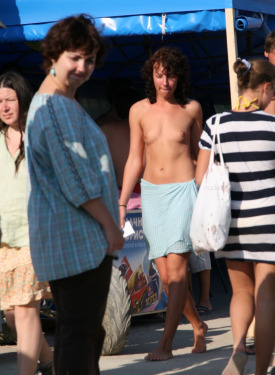 Topless candid trio swimming by the beach